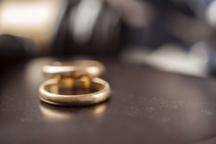 wedding rings on a desk, awaiting divorce settlement