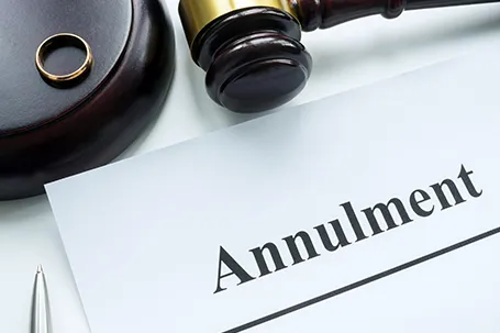 Papers about annulment, ring and a gavel.