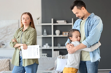 Little girl hugging her father after divorce at home.