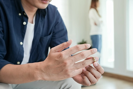 A man remove their wedding ring with desperation and disappointed on their marriage life.