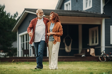 A healthy senior couple walking outdoors.