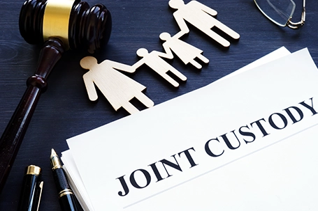 A documents, figure of family and gavel in table.