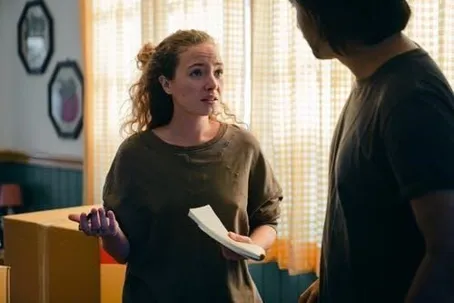 A man and a woman arguing while the woman is holding a piece of paper.