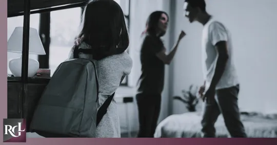 A child with a backpack watching her parents argue inside a bedroom.
