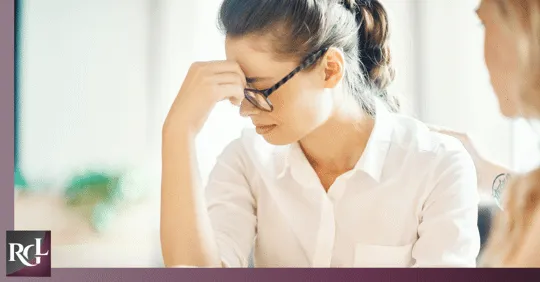An image of two girls — one of them looks sad and seems to be crying.