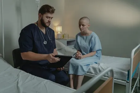 An image of a doctor and a patient, where the doctor is reading the results to the patient.