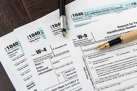 1040 tax form with pen, finance document.