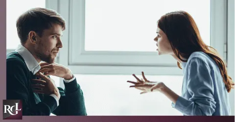 A man and a woman arguing while facing each other.