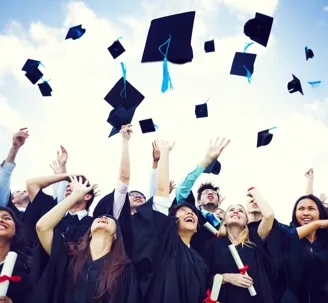 An image of college graduates happily throwing their graduation caps into the air.