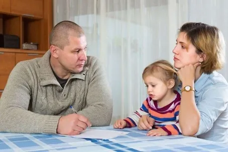 An upset couple discussing a parenting plan for their child.